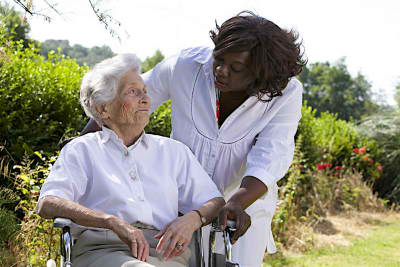 caregiver looking at senior woman